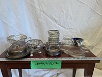 Entire lot of crystal and silverplate items on table