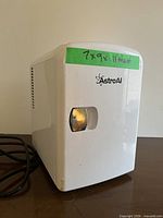 Front view of white AstroAI mini fridge showing size note