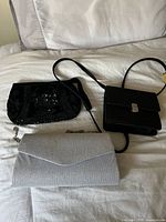 Three handbags displayed together