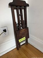 chair folded against wall showing overall folded profile