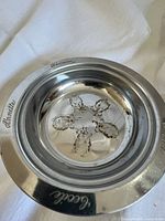 Top view of dish showing interior embossing and engraved names