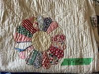 Close-up of a Dresden Plate block showing fabric prints and hand stitching