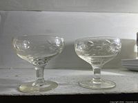 Front view of both etched coupe glasses