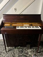 Front view of Fleetwood electric organ showing keyboard, control panel, foot pedal