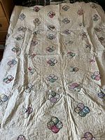 Quilt laid on bed showing overall size and pattern