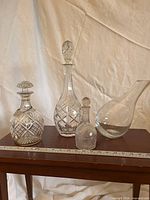 Four glass pieces on table showing overall lot