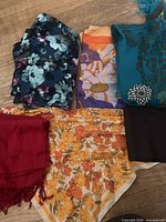 All six scarves laid out showing colours and patterns