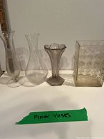 Group shot of four glass vessels lined up