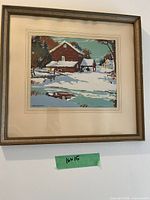 Framed winter landscape print on wall with green size note