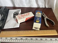 Stapler, envelope of clips, staple boxes, hole punch, ruler