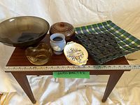 All six bowls and dishes displayed on table with ruler for scale