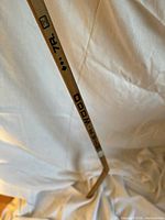 Full view of Sher-Wood wooden stick showing brand logo and overall wear