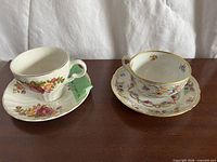 Both teacup and saucer sets side by side on table