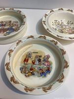 Close view of three bowls showing different interior scenes and staining