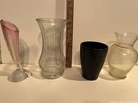 All four vases lined up beside ruler for scale