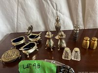 Group shot of entire condiment set on tabletop, showing all eleven pieces together