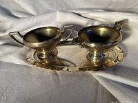 Creamer, sugar bowl and tray displayed together