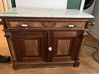 Front view showing marble top, drawer, doors, porcelain pulls