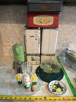 Group view of all items including canisters, tins, glassware and figurines