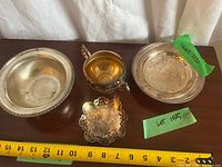 All four silver-plated pieces with tape measure