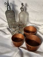 Group shot of both soda siphons, three wooden bowls and four tumblers