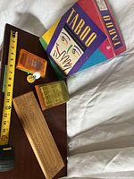 Group shot of Taboo box, cribbage board, travel basketball game, word cube game