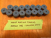 Stacks of WWII Canadian meat ration tokens with note showing approx quantity