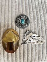 Front view of all three brooches