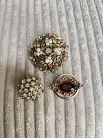 Three brooches grouped on fabric
