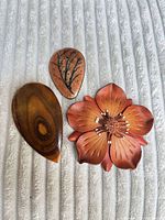 Front view of three brooches showing materials and shapes