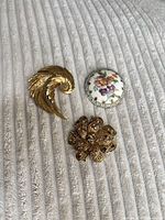 All three brooches grouped