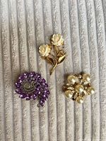 Front view showing three brooches