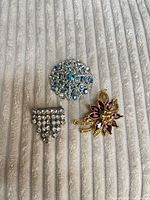 Front view showing all three brooches and stone colors