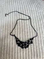 Full view of necklace showing chain and bib section