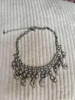Full view of rhinestone bib necklace showing overall design and extender chain
