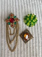 All three brooches laid out together
