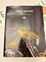 Front cover showing title, year and motorcycle graphic with creasing