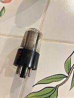 Side view of 6SN7 tube showing glass envelope and black octal base