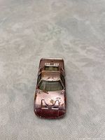 Front top view of pink diecast toy car showing paint wear