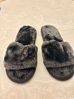 Top view of both slippers showing faux fur uppers and open-toe design