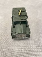 Front/top view showing overall condition, olive drab paint, yellow antenna in place
