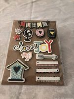 Front of sealed package showing all 13 foam embellishments on backing card