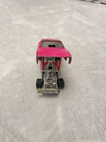 Front view with flip-top open showing detailed engine and missing grill piece