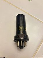 Side view of RCA 6N7 vacuum tube displaying black metal envelope and yellow markings