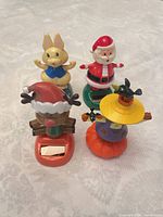 Front view of all four solar bobble figures