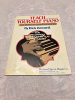 Front cover showing title, author, publisher logo and image of piano keys