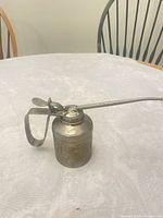 oil can front view showing handle and spout