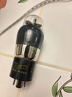 Overall view of Zenith 6V6 vacuum tube showing glass envelope and printed base