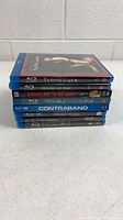Stack of eight Blu-ray cases side view showing spines and titles