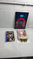 All three items laid out: framed Lex Luthor print, Poison Ivy print, Who’s Who comic